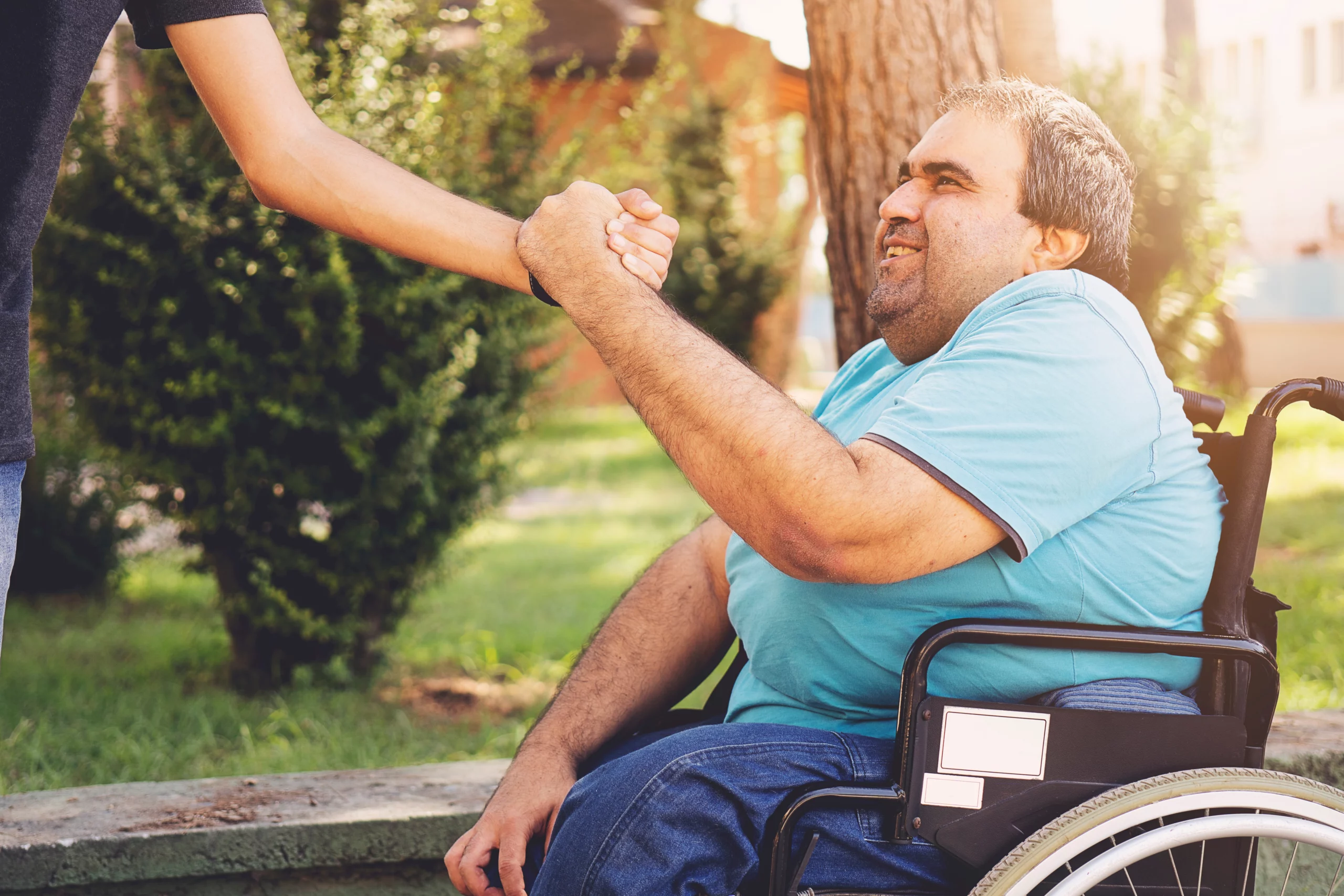 A support professional and participant smiling together during an adult day program