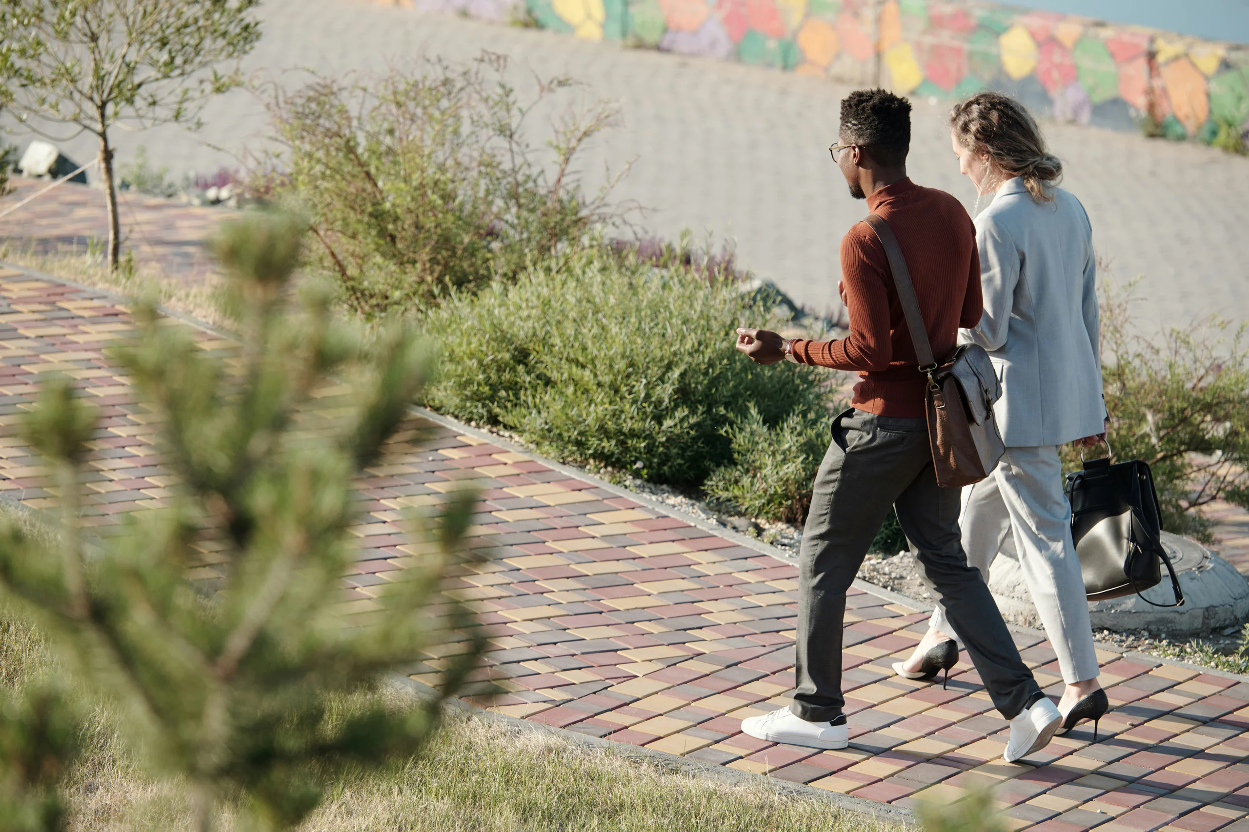 Two Inclusion Oriented team members walking and talking together